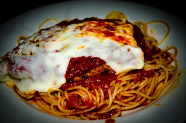 Chicken Parmigiana · Chicken cutlet breaded and sauteed in tomato sauce with mozzarella cheese served spaghetti or penne same sauce.