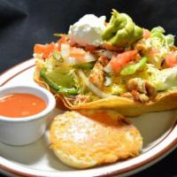Taco Salad · Garden greens topped with perfect seasoned chicken strips, grilled onions, bell green pepper...