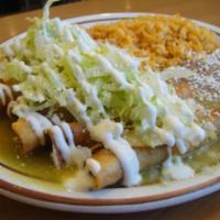Tacos Dorados · 6 rolled hard shell tacos stuffed with pollo a la Mexican and covered with our delicious tom...
