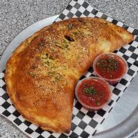 Greek Calzone · Mozzarella cheese, feta cheese, spinach, tomatoes, banana peppers and lamb gyro meat. Served...
