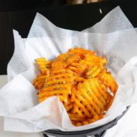 Waffle Fries · Waffle fries tossed with house seasoning, and Parmesan cheese topped with parsley flakes. Se...