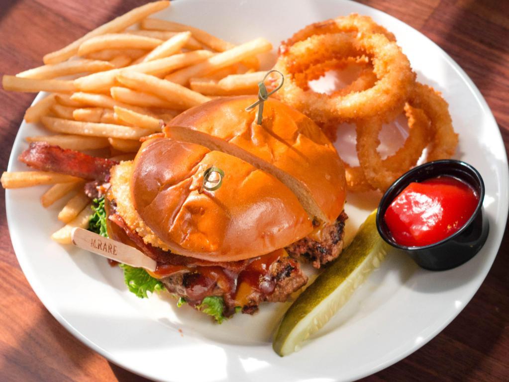 BBQ Burger · With onion rings, cheddar, applewood bacon and BBQ sauce. Served on a brioche bun with lettuce, tomato, onions and a crisp pickle spear with shoestring fries.