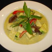 26. Green Curry · Green curry paste in coconut milk with zucchini, eggplants, green beans, basil and bell pepp...