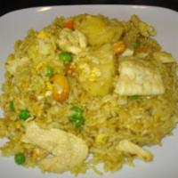 34. Pineapple Fried Rice · Stir-fried jasmine rice with pineapple, egg, carrots, peas, yellow powder curry, raisins and...
