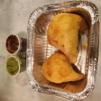 Vegan Samosa 🌿 · Deep fried crispy stuffed puffs with spiced potatoes and green peas served with mint and tam...