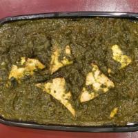 Saag Paneer · Cubes of cottage cheese and creamy spinach cooked in tomato onion gravy and tempered with mu...