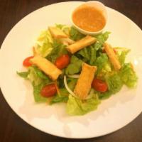 Garden Salad · Crispy tofu, lettuce, carrots, white onions, cherry tomatoes and cucumbers. Served with sauc...