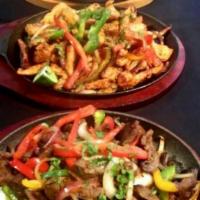 Chicken Fajitas · Onion, peppers and tomato. Served with rice and beans, topped with a creamy cheese sauce.