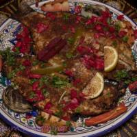 2-3 lb. Samak Masguf · Grilled wild caught whole tilapia back split, bone in, tail and head on and seasoned with a ...