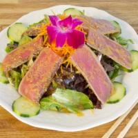 Black Pepper Seared Tuna Salad · Black pepper encrusted tuna pan seared and served with organic mixed greens, cucumber and to...