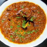 Goat Madras (HALAL) · Chunks of goat meat on the bone marinated in fresh tomatoes and lemon, cooked with potatoes,...