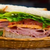 Ham and Cheddar Sandwich · Black forest ham and cheddar on white bread with lettuce, tomato, mayo and whole grain musta...
