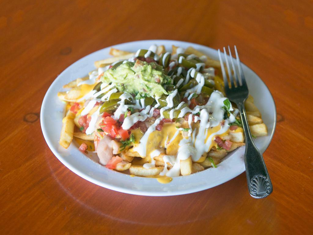 Carne Asada Fries · Made to order french fries smothered in refried beans, nacho cheese, pico de gallo jalapeno sour cream guacamole and made to order carne asada.