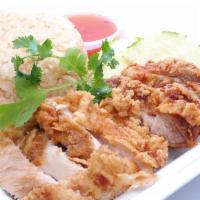 Hainan Fried Chicken Rice · Light battered fried chicken with garlic ginger rice and sweet chili sauce.