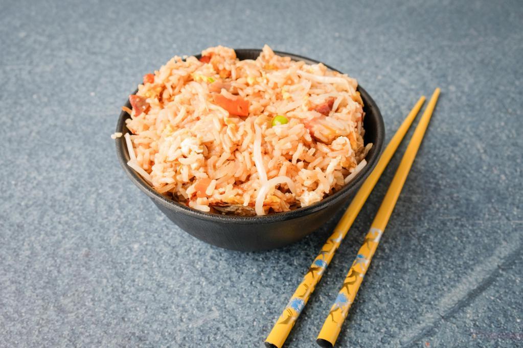 33. Fried Rice · Stir-fried steamed rice with roast pork, onion, bean sprout, carrots, peas and eggs in soy sauce.