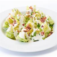 Wedge Salad · Iceberg lettuce, bacon, green onion, blue cheese dressing.