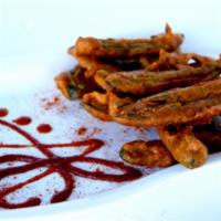 Chili Pakoras · Crispy, spicy green chilies with a coating of chickpea flour.