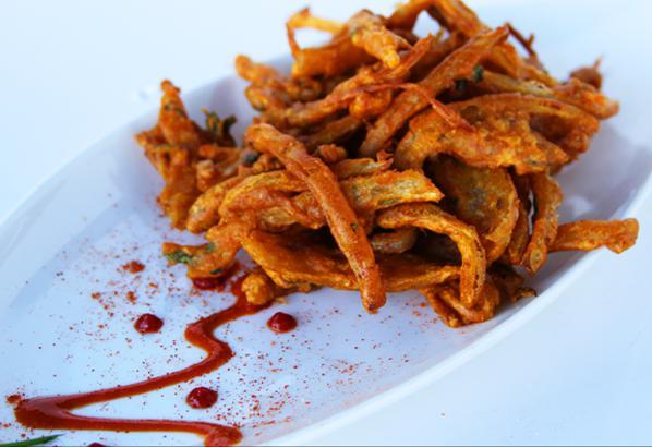 Onion Bhaji · Onions dusted in Indian herbs, spices and chickpea flour.