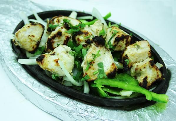 Murg Malai Kabab · Tender cubes of chicken marinated in a mild blend of yogurt, cardamom & coriander with a splash of cream. Cooked to perfection in the tandoor (clay oven). Gluten free.