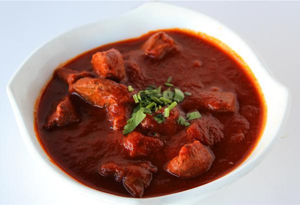 Rogan Josh · An exotic dish Kashmir simmered in house tomato sauce and seasoned with a flavorful blend of spices. Accompanied with saffron rice. Gluten-free. Vegan.