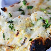 Garlic Naan · Our classic naan brushed with fresh garlic & herbs. Baked in our traditional clay tandoor ov...