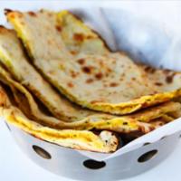Aloo Naan · Soft naan stuffed with spiced potatoes. Baked in our traditional clay tandoor oven from India.