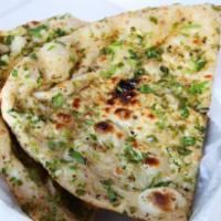 Bullet Naan · Spicy green chilis atop naan bread. Baked in our traditional clay tandoor oven from India.