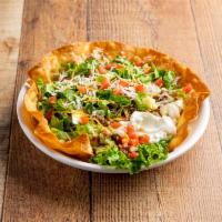 Taco Salad · Served with refried beans whipped with cheese, onions, spices, jalapenos, chopped lettuce, t...