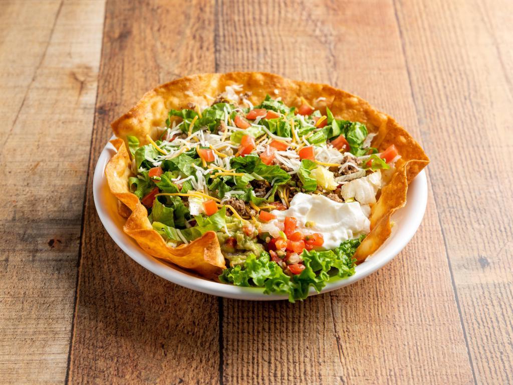 Taco Salad · Served with refried beans whipped with cheese, onions, spices, jalapenos, chopped lettuce, tomatoes and served with flour tortillas. Ensaladas caldos. Option to include meat.
