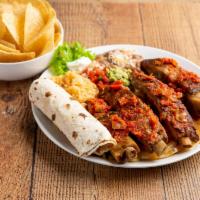 Costillas Ala Parrilla · Served with sauteed onions and bell peppers on sizzling skillet
