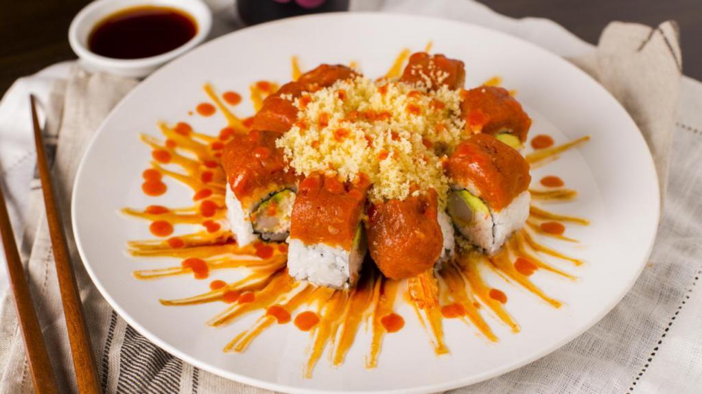Fire Roll · Fried shrimp, crab meat, avocado topped with spicy tuna, tempura flakes, eel sauce, spicy mayo, white mayo, sriracha. Spicy.