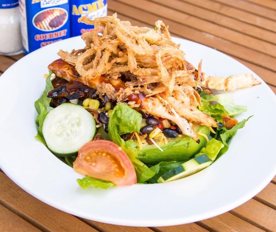 BBQ Ranch Chicken Salad · Grilled chicken breast, Applewood smoked bacon, fresh avocado, corn and black bean relish, shredded cheddar, tomatoes and cucumbers topped with crispy fried onions.