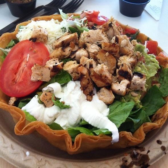 Tostada Salad · Crispy flour tortilla shell filled with romaine, black or pinto beans, guacamole, cheese, pico and sour cream.