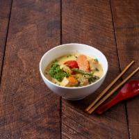 23. Green Curry · Spicy green curry paste with zucchini, eggplant, bell pepper and basil.