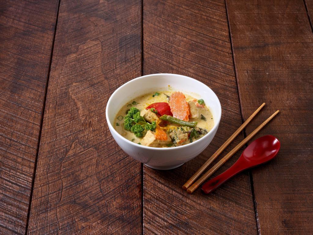 23. Green Curry · Spicy green curry paste with zucchini, eggplant, bell pepper and basil.