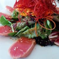 Tuna Tataki Salad · Sliced seared ahi tuna and mixed greens topped with mango vinaigrette, shelled edamame and g...