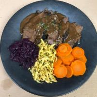 Sauerbraten · braised beef in vinegar and red wine gravy, served with spatzle, red cabbage, boiled carrots