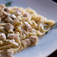 Fettuccine Alfredo with Grilled Chicken · Served with a side of garlic bread and Romano cheese. 