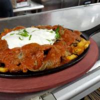 Iskender Kebab · Lamb gyro meat served with garlic, Infused yogurt and tomato sauce over Turkish bread. Does ...