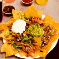 Nachos · Corn chips topped with lettuce, guacamole, sour cream, melted Jack and cheddar cheese, fresh...
