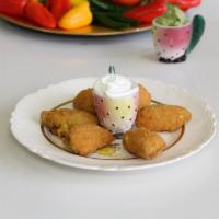 Jalapeno Poppers · Jalapenos stuffed with cheddar, served with sour cream.