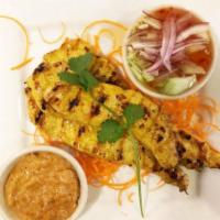 Chicken Satay · Chicken marinated with yellow curry paste and coconut milk served with cucumber salad and pe...