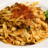 Fettuccine Pavarotti · Fresh made fettuccine, meat sauce, porcini and touch of cream.