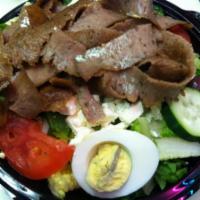 Gyros Salad · Our Greek salad is topped with gyros meat served with gyro sauce, Greek dressing and a pita....