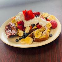 Mom's French Toast · Sliced challah bread dipped in our egg batter. Topped with raspberries, strawberries, bluebe...