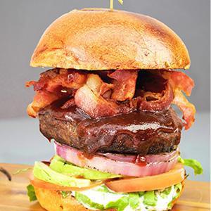 Tex Mix Burger · 6 oz. Angus beef patty, brioche bun, jalapeno, aged cheddar cheese, house BBQ sauce, grilled red onions, crispy bacon, house pickles, butter lettuce and tomatoes.