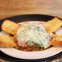Oven Baked Lasagna · Served with freshly baked garlic bread.