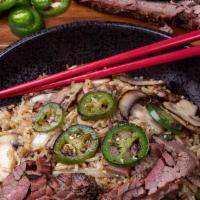 Brisket Jalapeno Fried Rice · Fried rice mixed with smoked brisket, charred onions, jalapenos and mushrooms. Spiced up wit...