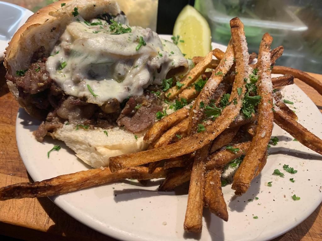 Shaved Steak Sandwich · 6 oz. shaved ribeye cooked in au ju with your choice of freshly cooked mushrooms, onions and peppers with your choice of cheese on top. Comes with homemade fries and or onion rings.