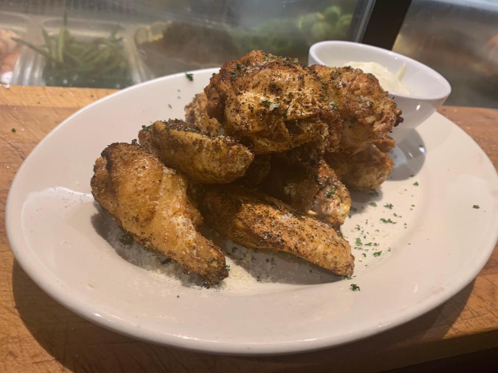 Chicken Wings and Fries · Jumbo wings fried naked in your choice of sauces. Comes with choice of ranch or bleu cheese side. Comes with small side of homemade Parmesan fries.